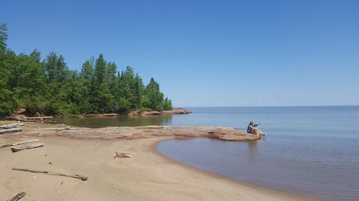 People at Quarry Beach in the Port Wing Boreal Forest.