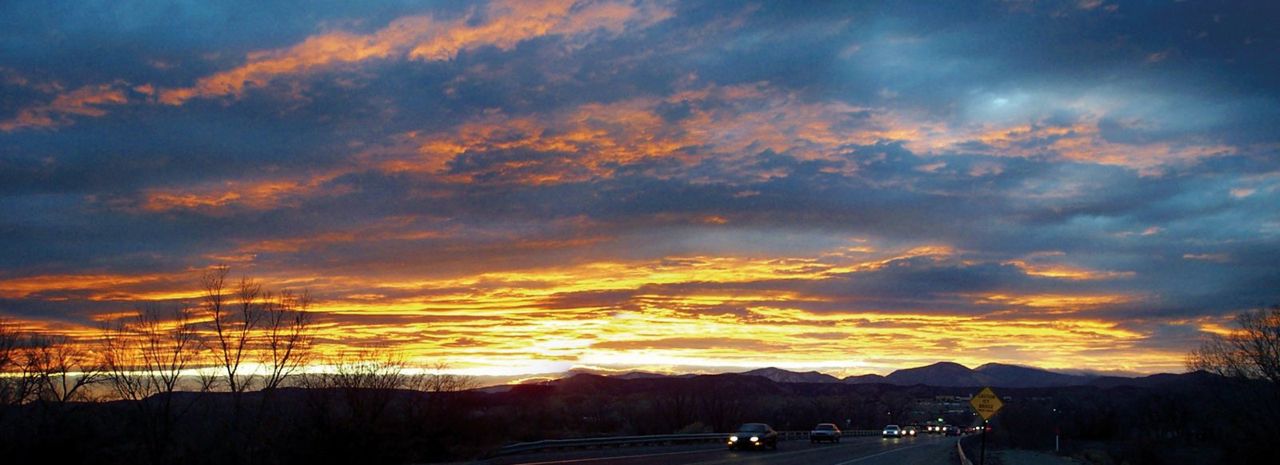 A glorious sunset provides a spectacular ending to the day for homebound drivers. One can almost feel their relief crossing the Rio Grande on their way home. Many of the residents of the Española Valley can trace their roots back to the time of O&ntilde;ate and for the Pueblo Indians even further back. Like their ancestors of centuries past, they still travel El Camino Real home.