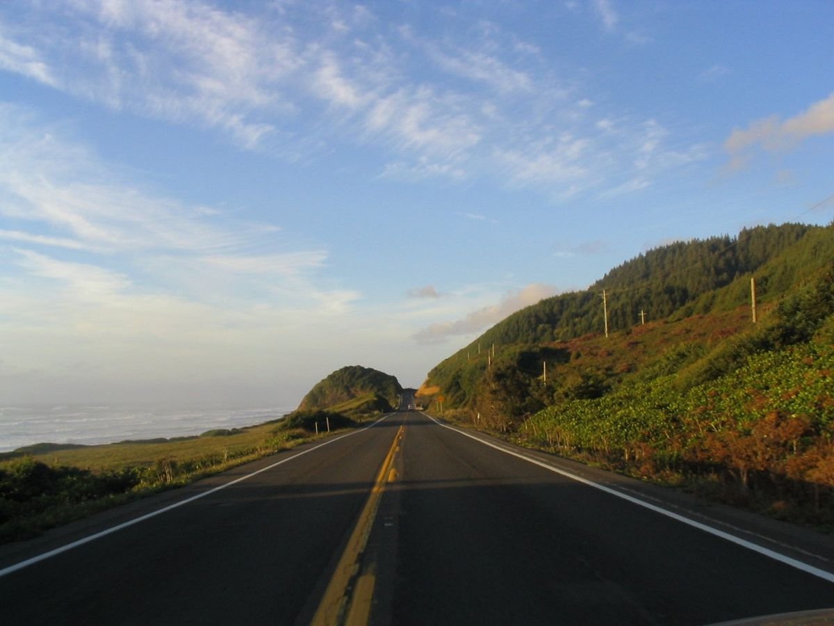 The Pacific Coast Scenic Byway in Oregon combines a drive along the beach with a drive through the forest.  The byway is bordered by the Pacific Ocean to the west and pine-covered mountains to the east.