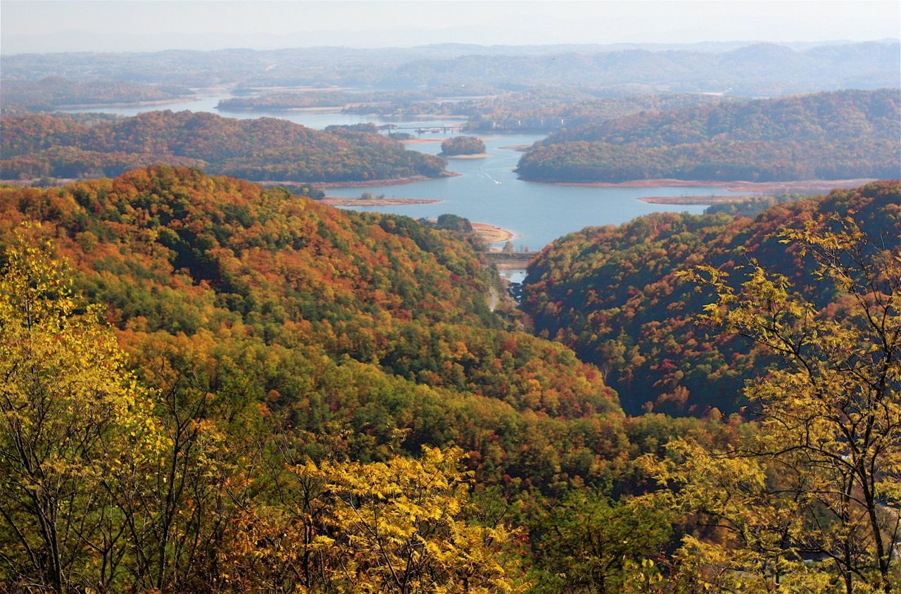 From high atop Clinch Mountain, one can see south across the forested, winding shorelines of Cherokee Lake to the misty Great Smoky Mountains in the distance, a long, serene view of a broad valley with extensive lakes stretching in all directions. This was the route and landscape through which passed the East Tennessee Crossing — the Warriors Path, the Wilderness Road, and the Dixie Highway.