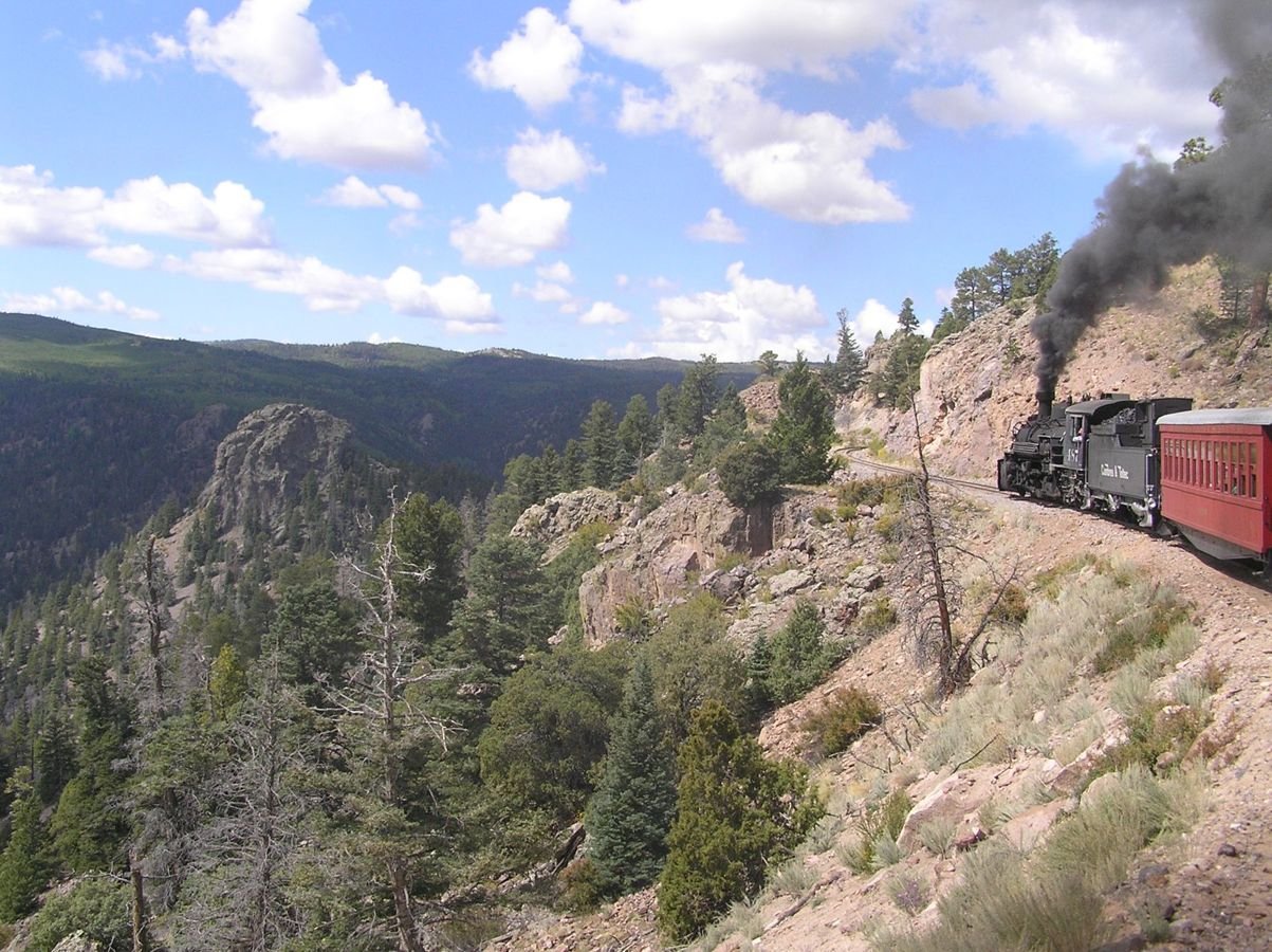 A train crossing mountain country on the Cumbres & Toltec Scenic Railroad.